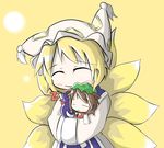  ^_^ animal_ears aoblue blonde_hair blush brown_hair carrying cat_ears chen chibi closed_eyes fox_tail hat long_sleeves multiple_girls multiple_tails pillow_hat short_hair sleeping smile tail tassel touhou wide_sleeves yakumo_ran yellow_background zzz 