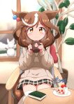  1girl absurdres animal_ears blurry blurry_background blush book brown_hair cake chair closed_mouth cup food hat highres holding horse_girl looking_at_viewer matikane_tannhauser_(umamusume) matty_(matsutomo) mug plant potted_plant sitting smile snowman solo table umamusume unworn_hat unworn_headwear window yellow_eyes 