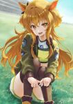  1girl animal_ears bomber_jacket commentary_request crop_top dog_tags ear_ornament grass green_jacket green_thighhighs highres horse_ears horse_girl jacket knees_up long_hair long_sleeves looking_at_viewer mayano_top_gun_(scramble_zone)_(umamusume) mayano_top_gun_(umamusume) midriff on_ground open_clothes open_jacket open_mouth orange_eyes orange_hair short_shorts shorts sitting smile solo tank_top thighhighs umamusume white_shorts yellow_tank_top yun_bo_(yumbocchi) 
