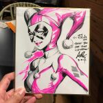  1girl artist's_hand_in_frame batman_(series) breasts commentary dc_comics domino_mask english_commentary eye_mask harley_quinn harley_quinn_(classic) hat jester jester_cap jester_costume marker_(medium) mask parted_lips photo_(medium) shikishi signature sketch solo stanley_lau thank_you traditional_media upper_body 