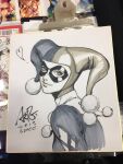  1girl batman_(series) closed_mouth commentary dc_comics domino_mask english_commentary eye_mask from_side harley_quinn harley_quinn_(classic) hat jester jester_cap jester_costume marker_(medium) mask photo_(medium) shikishi signature smile solo stanley_lau traditional_media turning_head 