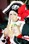  1girl banana breasts captain_liliana captain_liliana_(cosplay) chouzuki_maryou cosplay food fruit hat highres large_breasts lost_worlds photo pink_hair pirate pirate_hat plump purple_eyes queen&#039;s_blade queen's_blade queen's_blade_rebellion sexually_suggestive 