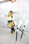  1girl asian blonde_hair breasts brown_eyes chouzuki_maryou cosplay drill_hair fingerless_gloves gloves gun hat large_breasts magical_musket mahou_shoujo_madoka_magica musket photo plump solo tomoe_mami tomoe_mami_(cosplay) twin_drills weapon 