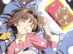  :o antenna_hair bangs bed_sheet book brown_hair cardcaptor_sakura child closed_eyes crescent from_above glowing hand_on_own_chest head_tilt highres jpeg_artifacts kero kinomoto_sakura light_particles long_sleeves lying messy_hair official_art on_back on_bed pajamas pillow short_hair sleeping star star_print sun_(symbol) under_covers upper_body 