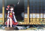  ascot bad_id bad_pixiv_id black_hair bow bucket bucket_of_water cup detached_sleeves drinking_glass electric_fan fan grass hair_bow hair_tubes hakurei_reimu highres long_sleeves looking_at_viewer red_eyes shirt shoes_removed sitting skirt skirt_set soaking_feet solo toake_mikage touhou veranda wide_sleeves wind_chime 