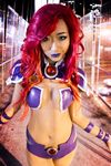  1girl breasts cleavage cosplay dc_comics green_eyes hip_vent long_hair photo red_hair solo starfire 