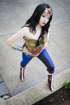  1girl amazon black_hair boots cosplay dc_comics hands_on_hips pants photo solo strapless tiara wonder_woman wonder_woman_(cosplay) wonder_woman_(series) 