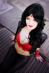  1girl amazon black_hair breasts cleavage cosplay dc_comics jacket leather leather_jacket leather_pants looking_at_viewer pants photo sitting solo tiara vambraces wonder_woman wonder_woman_(cosplay) wonder_woman_(series) 