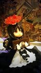  akemi_homura black_bow black_dress black_hair bow doll dress figure flower full_body funeral_dress guillotine hairband lock long_hair mahou_shoujo_madoka_magica mahou_shoujo_madoka_magica_movie photo red_eyes restrained sitting solo spider_lily spoilers stocks 