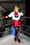  1girl asian blonde_hair blue_eyes boxing_ring breasts chouzuki_maryou cosplay fingerless_gloves gloves large_breasts miss_spencer miss_spencer_(cosplay) photo rumble_roses rumble_roses_xx solo 