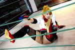  1girl asian blonde_hair blue_eyes boxing_ring breasts chouzuki_maryou cosplay fingerless_gloves gloves large_breasts miss_spencer miss_spencer_(cosplay) photo rumble_roses rumble_roses_xx solo 