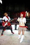  arena blonde_hair boxing_ring breasts candy_cane_(rumble_roses) candy_cane_(rumble_roses)_(cosplay) chouzuki_maryou cleavage cosplay fingerless_gloves glasses gloves guitar instrument large_breasts miss_spencer miss_spencer_(cosplay) multiple_girls photo red_hair rumble_roses rumble_roses_xx suzuka_itsuki 