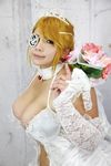  1girl blonde_hair blue_eyes boquet breasts bridal_veil chouzuki_maryou cleavage cosplay dress eyepatch gloves large_breasts mistress_spencer mistress_spencer_(cosplay) photo rumble_roses rumble_roses_xx solo tiara veil wedding_dress 