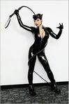  1girl animal_ears artist_name batman_(series) bodysuit breasts cat_ears catwoman catwoman_(cosplay) cleavage cosplay dc_comics goggles latex latex_suit photo solo standing whip yaya_han 