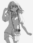  1girl absurdres bow bowtie camera camera_around_neck cowboy_shot greyscale hand_in_own_hair hand_up highres long_hair looking_at_viewer miniskirt monochrome original pleated_skirt school_uniform shimkarom short_sleeves skirt solo sweater_vest 