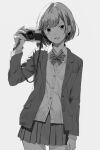  1girl blazer bob_cut bow bowtie camera cowboy_shot greyscale hand_up highres holding holding_camera jacket looking_at_viewer miniskirt monochrome open_mouth original pleated_skirt school_uniform shimkarom short_hair simple_background skirt smile solo sweater_vest 