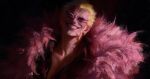  1boy absurdres black_background blonde_hair coat collarbone collared_shirt donquixote_doflamingo earrings feather_coat grin highres jewelry male_focus one_piece pink_coat shirt short_hair smile solo sunglasses teeth veiny_face whitehogiii 