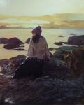  1girl beanie commentary_request hat highres horizon mountainous_horizon naohiro_ito nature ocean oil_painting_(medium) original outdoors painting_(medium) rock scenery shore solo traditional_media water 