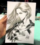 1girl art_tools_in_frame artist's_hand_in_frame breasts closed_mouth collarbone commentary cropped_torso dc_comics english_commentary highres looking_at_viewer marker_(medium) monochrome photo_(medium) serious signature sketch solo stanley_lau supergirl superman_(series) superman_logo traditional_media white_background 