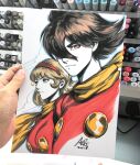 1boy 1girl art_tools_in_frame artist's_hand_in_frame blonde_hair blue_eyes breasts brown_hair closed_mouth commentary cyborg_009 english_commentary francoise_arnoul hair_over_one_eye hairband highres looking_ahead looking_at_viewer marker_(medium) photo_(medium) red_hairband red_shirt scarf shimamura_joe shirt stanley_lau traditional_media yellow_scarf 