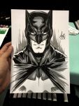  1boy art_tools_in_frame artist's_hand_in_frame bat_mask batman batman_(series) batman_symbol black_mask commentary cowl cropped_torso dc_comics english_commentary facing_viewer highres male_focus marker_(medium) mask monochrome parted_lips photo_(medium) signature sketch solo stanley_lau traditional_media 
