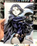  1girl art_tools_in_frame artist's_hand_in_frame belt black_gloves blue_outline breasts cape commentary curtained_hair dc_comics english_commentary fingerless_gloves forehead_jewel gem_belt gloves highres leotard marker_(medium) outline parted_lips photo_(medium) purple_cape purple_hair purple_leotard raven_(dc) short_hair signature sleeved_leotard solo stanley_lau teen_titans traditional_media white_background 