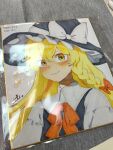  1girl absurdres black_hat black_vest blonde_hair blush bow braid closed_mouth dated hair_bow hat hat_bow highres kirisame_marisa long_hair looking_at_viewer niru_(ka_k_0517) photo_(medium) red_bow shikishi side_braid signature single_braid smile solo touhou traditional_media translation_request upper_body vest white_bow witch_hat yellow_eyes 