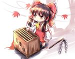  ascot autumn autumn_leaves bad_id bad_pixiv_id bow box brown_eyes brown_hair check_commentary commentary_request detached_sleeves donation_box dress gohei hair_bow hair_tubes hakurei_reimu kotou_(ko-tou) long_sleeves open_mouth red_dress solo touhou wide_sleeves wind younger 