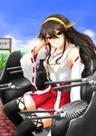  adjusting_hair black_legwear brown_eyes brown_hair cannon dazzle_paint detached_sleeves hairband haruna_(kantai_collection) highres kantai_collection long_hair machinery nontraditional_miko skirt solo striped thighhighs torohi_(marutorohi) turret 