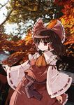  architecture bow brown_hair detached_sleeves east_asian_architecture hair_bow hakurei_reimu hitsuji_(artist) red_eyes short_hair solo touhou 