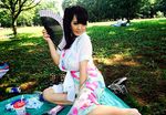 1girl asian black_hair breasts grass hitomi_tanaka huge_breasts photo picnic solo 