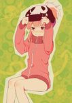  beanie blush directional_arrow green_background hands_on_headwear hat heart jacket jakuzure_nonon kill_la_kill knees_touching long_sleeves looking_up monokuro_(snog) outline pink_eyes pink_hair short_hair sidelocks sitting skull solo track_jacket 