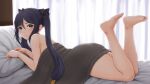  1girl bare_shoulders barefoot bed_sheet black_hair blush duzimura feet feet_up genshin_impact green_eyes legs long_hair looking_at_viewer looking_back lying mona_(genshin_impact) on_stomach pillow soles solo toes twintails 