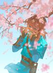  1boy absurdres arm_guards belt belt_buckle blonde_hair blue_background blue_eyes blue_tunic brown_belt brown_gloves buckle cherry_blossoms commentary_request cowboy_shot falling_petals fingerless_gloves gejiandenghuo gloves hair_between_eyes highres holding holding_leaf leaf leaf_in_mouth link looking_ahead male_focus petals ponytail sheikah_slate simple_background solo standing the_legend_of_zelda tunic 