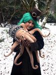  cephalopod coat cold cuddly eyewear feather female gloves goggles green_hair hair hat human mammal marine not_furry octopus smile snow steampunk stuffed_toy tentacles top_hat winter 
