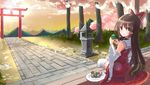  bow brown_eyes brown_hair cherry_blossoms cup dango detached_sleeves food hair_bow hair_tubes hakurei_reimu highres long_hair looking_at_viewer looking_back mountain outdoors parted_lips path pavement plate ribbon-trimmed_legwear ribbon-trimmed_sleeves ribbon_trim road running_bond sitting skewer solo stone_lantern sunset thighhighs torii touhou tree wagashi yunomi zx0602 