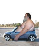  beard car convertible eyewear facial_hair giant human male mammal obese outside overweight solo 