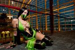  1girl arm_support asian breasts center_opening cosplay female half_mask indoors jade jade_(mortal_kombat) large_breasts looking_at_viewer mortal_kombat no_bra on_floor on_side photo revealing_clothes solo 