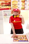  1girl asian bow bowtie brand_name_imitation breasts brown_eyes brown_hair chouzuki_maryou cosplay employee_uniform fast_food fast_food_uniform female food hamburger hataraku_maou-sama! large_breasts photo plump polo_shirt ribbon sasaki_chiho sasaki_chiho_(cosplay) short_hair short_twintails skirt solo twintails uniform visor_cap 