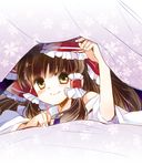  arm_up blanket blush bow brown_eyes brown_hair detached_sleeves floral_print hair_bow hair_ornament hair_ribbon hair_tubes hakurei_reimu long_hair long_sleeves looking_at_viewer lying on_bed on_stomach ribbon smile solo suzune_yuuji touhou wide_sleeves 