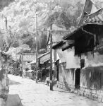  1boy brick_floor building child day greyscale highres monochrome mouen_tw original painting_(medium) path road shadow street sunlight terrace_(architecture) town traditional_media watercolor_(medium) 