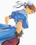  1girl absurdres ass_peek bracelet breasts brown_eyes brown_hair bun_cover chinese_clothes chun-li commentary dixiedannsan double_bun dress dutch_angle earrings english_commentary from_behind hair_bun hands_on_own_hips highres jewelry large_breasts looking_back pantyhose qipao simple_background solo spiked_bracelet spikes street_fighter white_background 