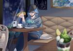  1boy alternate_costume black_hat black_pants blue_eyes blue_hair blurry blurry_foreground chair closed_mouth commentary_request cup food food_on_face grey_hoodie grusha_(pokemon) hand_up hat highres holding hood hood_down hoodie indoors male_focus mocacoffee_1001 pants plate pokemon pokemon_sv rotom rotom_phone saucer shoes signature sneakers solo table tassel white_footwear 
