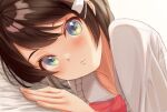  1girl :/ bed_sheet blue_eyes blush bow bowtie brown_hair close-up closed_mouth collared_shirt eyelashes green_eyes hair_ornament hair_ribbon hand_up highres hololive looking_at_viewer lying multicolored_eyes nojikorirakkusu on_side oozora_subaru oozora_subaru_(casual) red_bow red_bowtie ribbon shirt short_hair solo swept_bangs upper_body virtual_youtuber white_ribbon white_shirt 