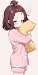  1girl absurdres bangs_pinned_back brown_hair closed_mouth commentary_request cowboy_shot forehead hair_bobbles hair_ornament highres hugging_object long_sleeves medium_hair pajamas pillow pillow_hug pink_pajamas pink_shirt pink_shorts red_eyes shiguren_39 shirt short_shorts shorts simple_background solo touhoku_kiritan voiceroid 