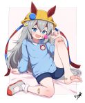  1girl :d absurdres aged_down animal_ears bandaid bandaid_on_cheek bandaid_on_face bandaid_on_knee bandaid_on_leg barefoot blue_eyes blue_shorts blue_sweater boppin candy commentary_request ear_covers ears_through_headwear fang food grey_hair grey_shoes hat highres holding holding_candy holding_food holding_lollipop horse_ears horse_girl kindergarten_uniform legs lollipop long_hair looking_at_viewer open_mouth shoes shorts signature sitting smile soles solo sweater tamamo_cross_(umamusume) two-tone_background umamusume yellow_hat 