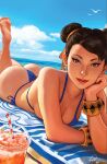  1girl ass asymmetrical_bangs backlighting barefoot beach beach_towel bikini bird blue_bikini blue_sky bracelet breasts brown_eyes brown_hair chun-li closed_mouth cloud collarbone commentary cup double_bun drink drinking_straw earrings east_asian english_commentary eyelashes eyeliner feet_out_of_frame feet_up freckles hair_bun hair_ribbon head_back head_rest highres ivan_talavera jewelry large_breasts light_smile lipstick looking_at_viewer lying makeup multiple_bracelets nose ocean on_stomach out_of_frame outdoors pearl_earrings red_eyeliner red_lips ribbon sand side-tie_bikini_bottom signature sky soles street_fighter swimsuit thong thong_bikini towel water western_comics_(style) yellow_ribbon 