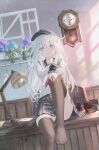  1girl absurdres black_hat black_skirt black_thighhighs blue_eyes blue_flower blush clock commentary desk desk_lamp envelope flat_cap flower hair_between_eyes hat hibiki_(kancolle) highres hydrangea indoors inkwell kantai_collection lamp leaf long_hair long_sleeves looking_at_viewer neckerchief no_shoes panties pantyshot pleated_skirt purple_flower red_neckerchief school_uniform serafuku sitting skirt sleeves_past_wrists solo table teruterubouzu thighhighs tomushi underwear wall_clock white_hair white_panties 