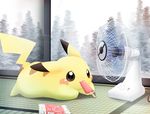  food gen_1_pokemon hot ice_cream lying mouth_hold no_humans on_stomach pemyu pikachu pokemon pokemon_(creature) solo sweat tree 
