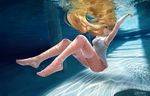  barefoot blonde_hair breasts cleavage long_hair oright original red_eyes signed thighhighs underwater water wristwear 